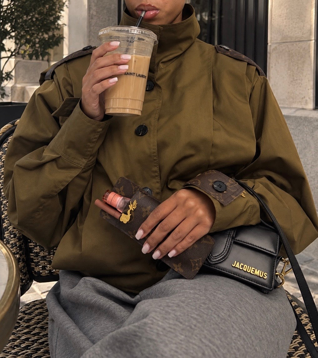 By Kay jacket and lip essentials styled at a café